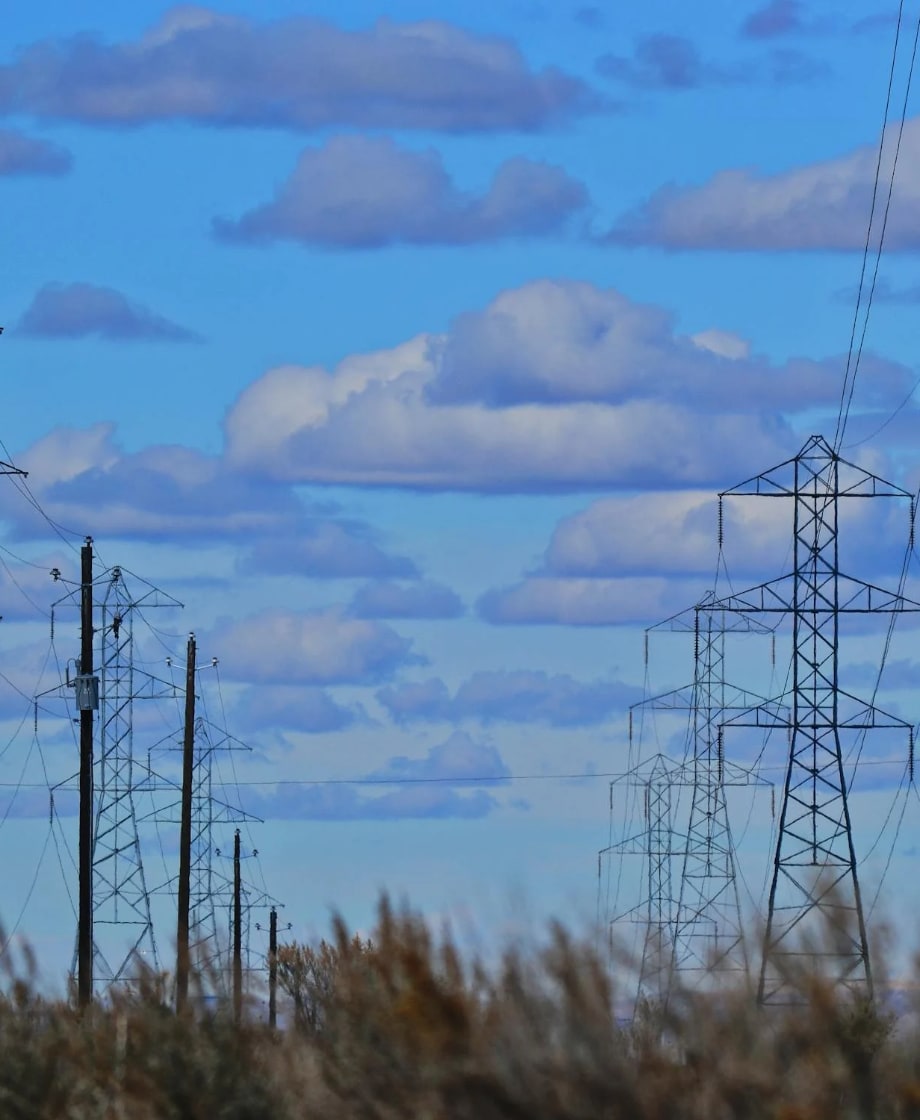 power line towers with blue sky and clouds