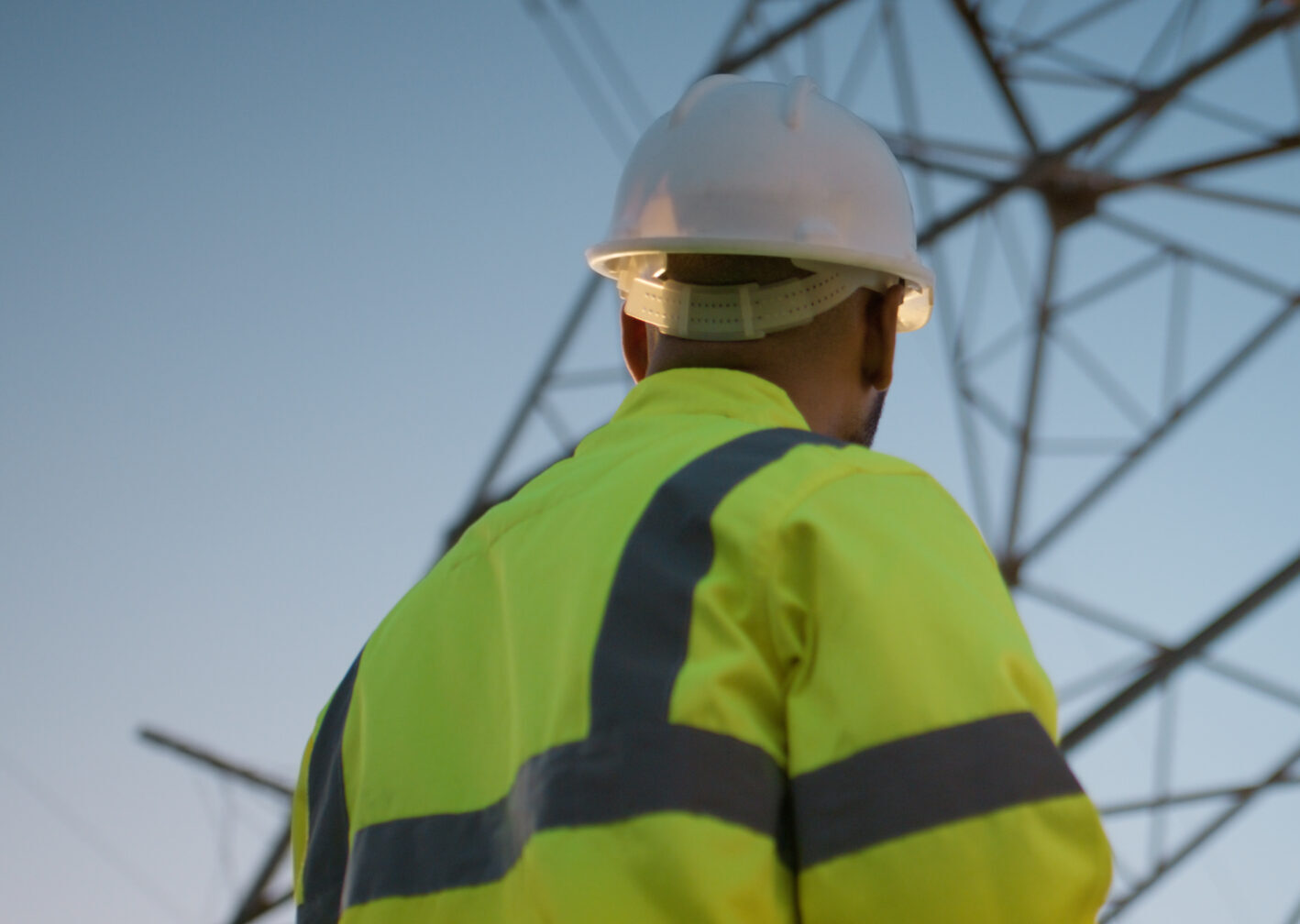 Teamwork electrical engineer and tablet in power station with sunset for electricity transmission and tower check